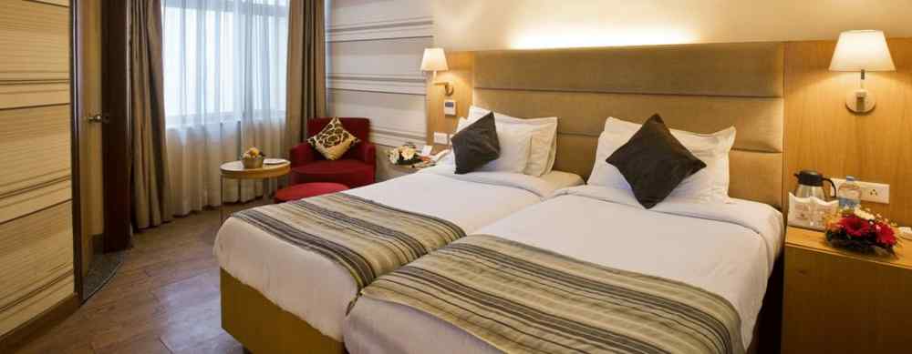 an image of a deluxe room with an air-conditioner at The Manor, Bareilly