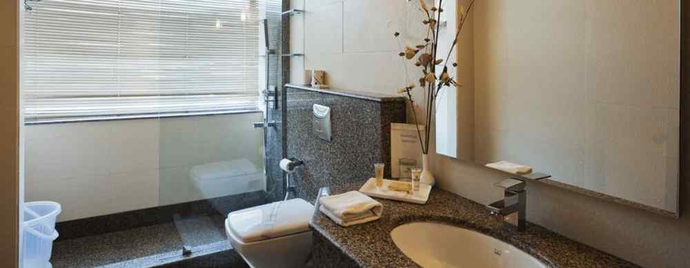 an image of a bathroom with a mirror at The Manor, Bareilly