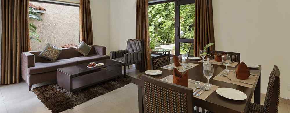 An image of a living area with sofa set and dining area on the other side. There is also a flat TV screen on the wall - The Riverview Retreat, Corbett