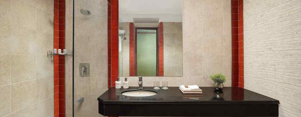 Bathroom vanity area at The Riverview Retreat Corbett with mirror washbasin and well lit modern setup