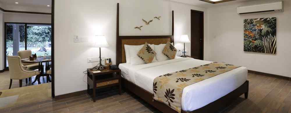An image of a bedroom with double size bed, flat TV screen, and a bedside table with lamp - The Riverside Retreat, Corbett