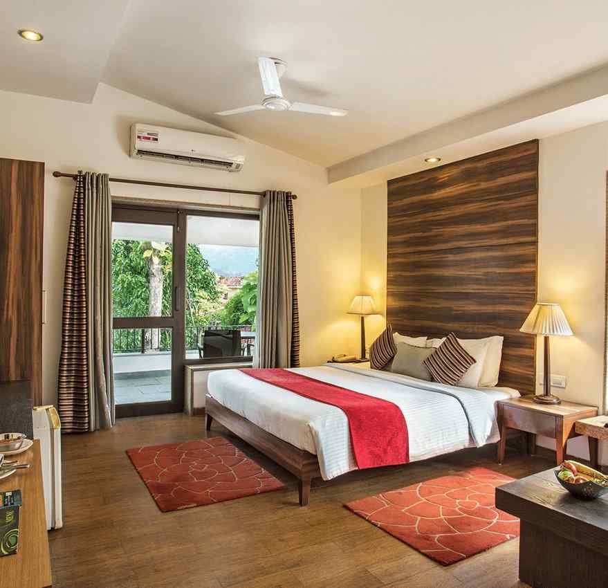 An image of a bedroom with king size bed, bedside table and lamp,  flat TV screen,  a cabinet , fan, and an open window - The Riverview Retreat, Corbett