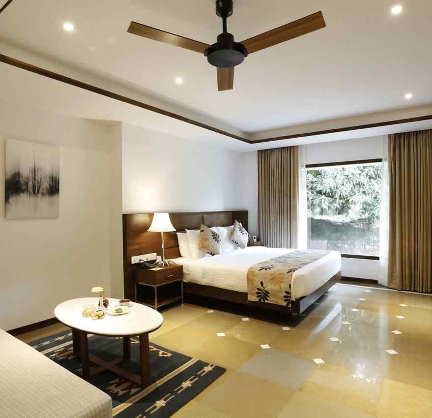 An image of a bedroom with king size bed, bedside table and lamp,  flat TV screen,  a cabinet , fan, and an open window - The Riverview Retreat, Corbett
