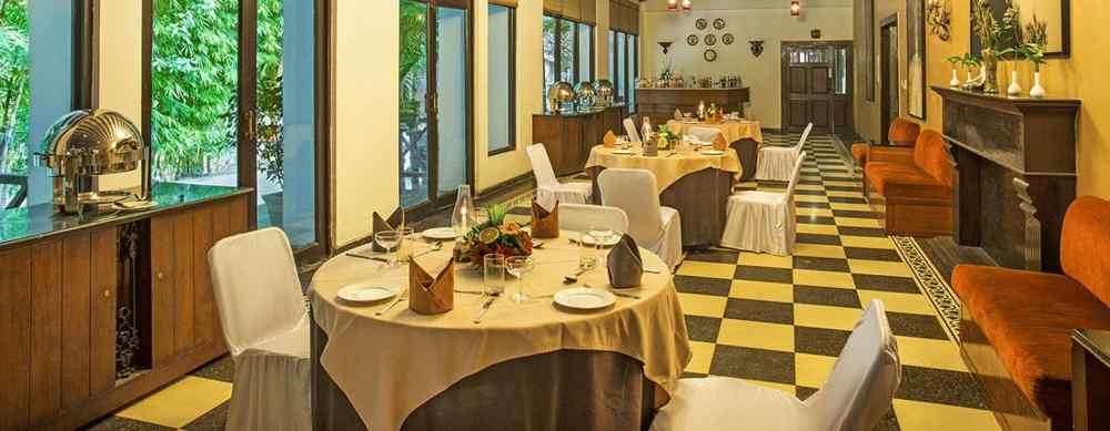 An image of a dining area with many table and chairs and a huge chandelier hanging from the ceiling- The Riverview Retreat, Corbett