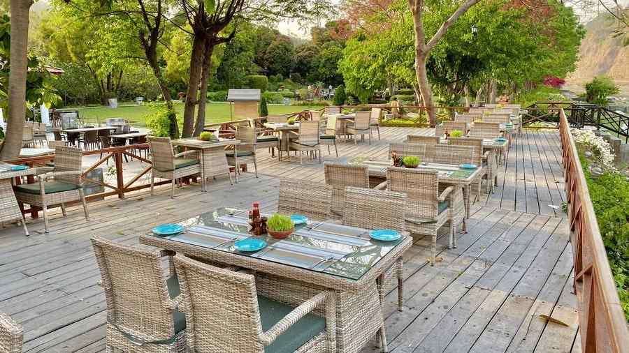 An image of seating area with wooden chairs and table - The Riverview Retreat, Corbett