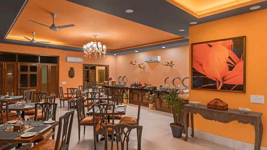 tables and chairs in clusters spread across a room with a buffet setting on the side - Atman, Dharamshala