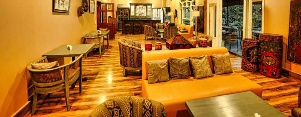 A image of Restaurant interior at Atman, dharamshala, with comfortable seating and warm lighting.