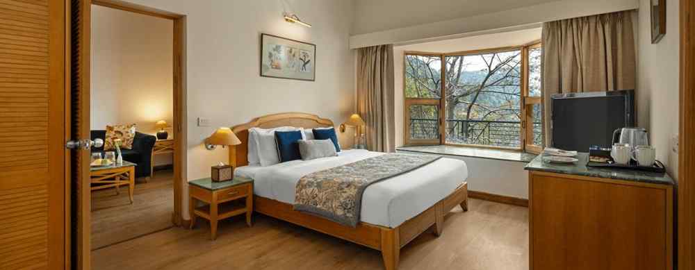 Superior Cottage Hill View with comfy bed, Tv, and window with a beautiful view at Baikuth resort, kasauli.