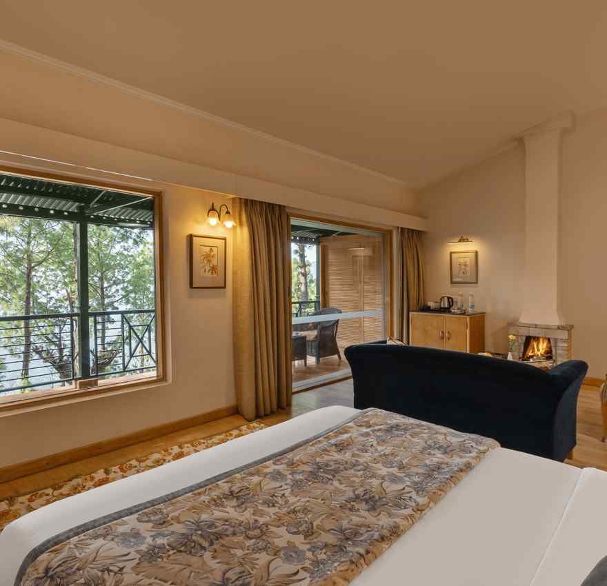 Premium Cottage with plushy bed a fire place and sofa along with TV at Baikuth resort, kasauli.