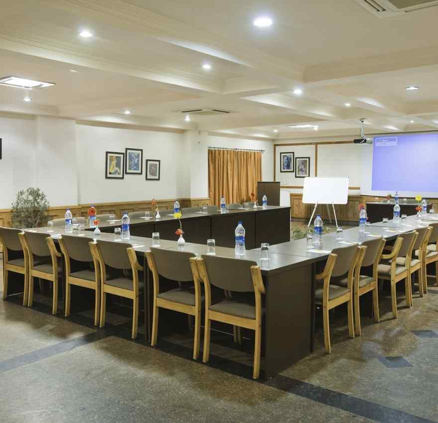 a corner view of a conference room with a U-shaped seating arrangement 