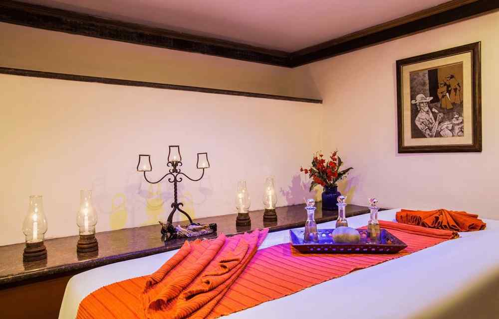 A spa table and candles beside it in a treatment room at our Spa in Nainital