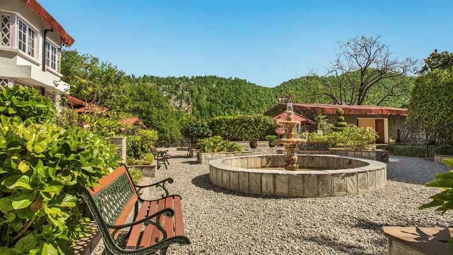 Image featuring Garden Sit-Out Area at the naini retreat, nainital. A fountain in the middle and 