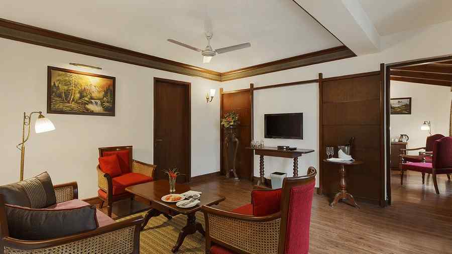 A full view of living room with 3 chairs and a table - the naini retreat, nainital.
