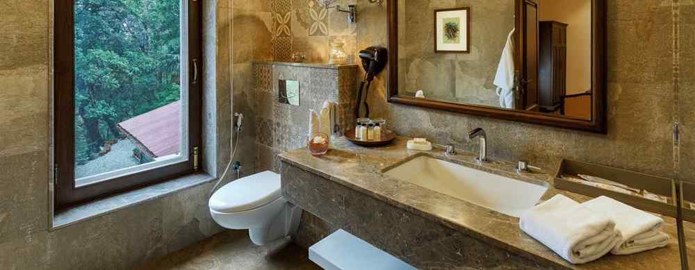 An image showing a washroom with a wooden mirror, a large window, marble floor decorated with an indoor painting - The Naini Retreat, Nainital