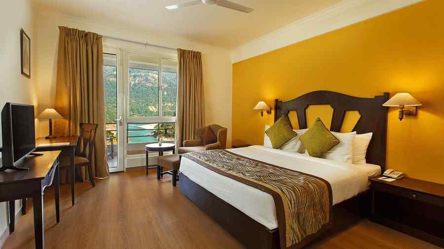 Two bedroom Apartment facing the Ganges with a large bed with side lamps and large windows - Aloha On The Ganges, Rishikesh